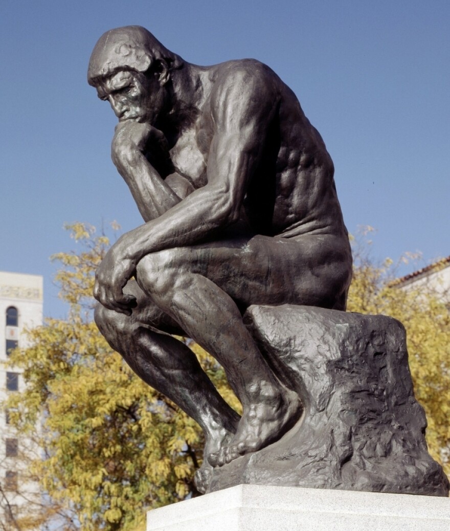 A picture of the sculpture of the thinker, by Rodin.